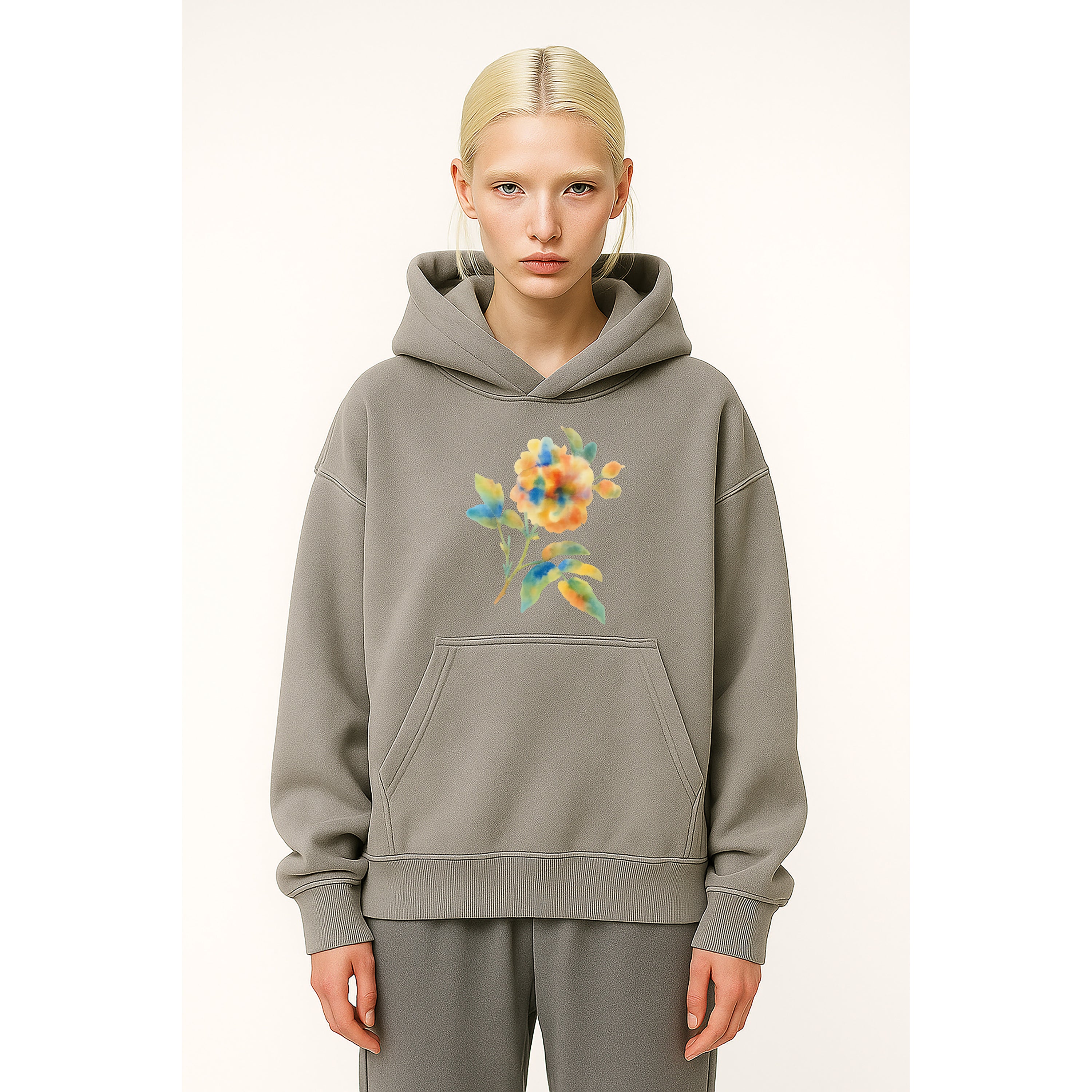 Model wears grey heavyweight hoodie with multicolor watercolor floral flower print
