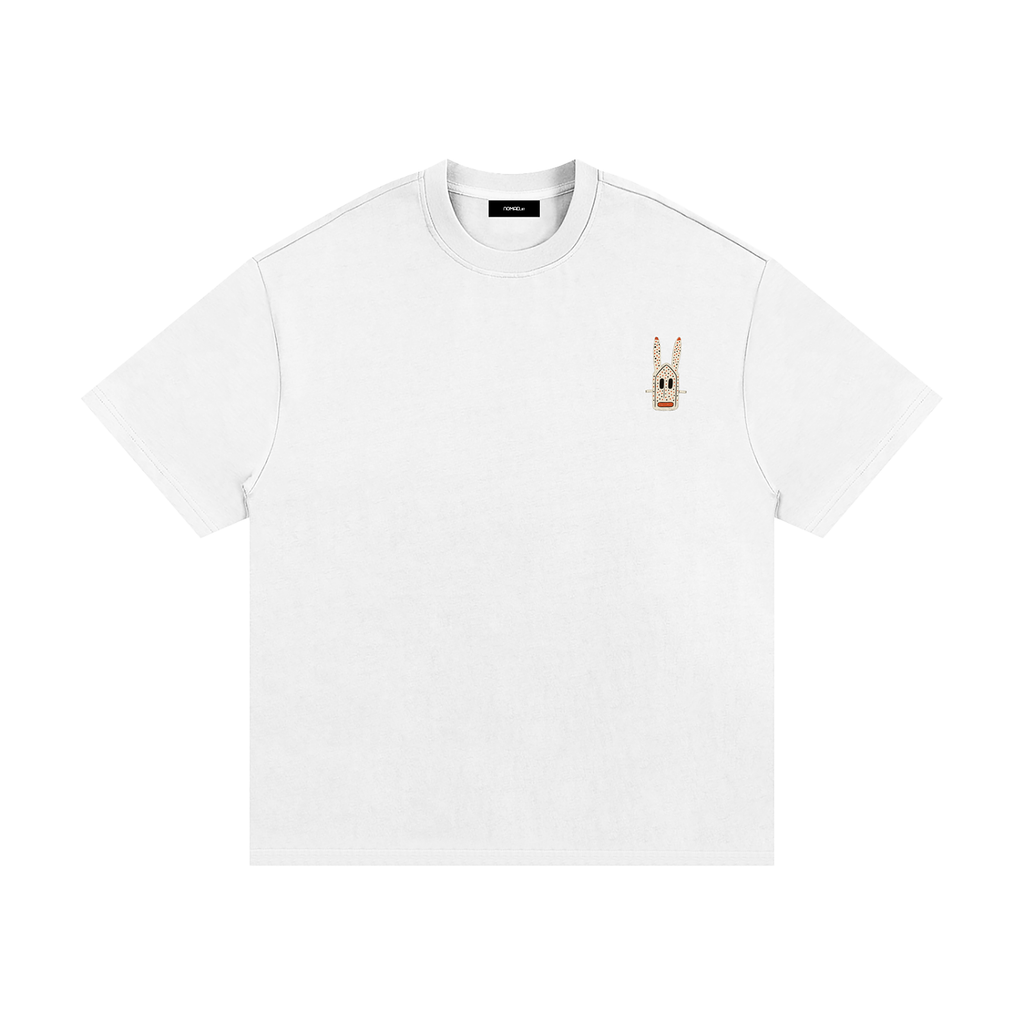 Unisex Chalk heavyweight T-shirt with small Dogon Rabbit chest graphic in cultural fusion style.