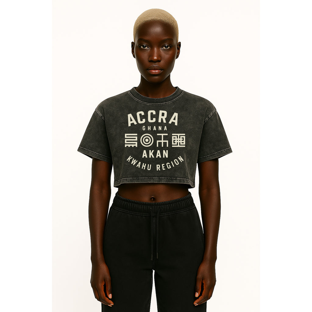 A model wears nomad_07 cropped Solar Patina t-shirt in Onyx with Accra Ghana Script graphic front view