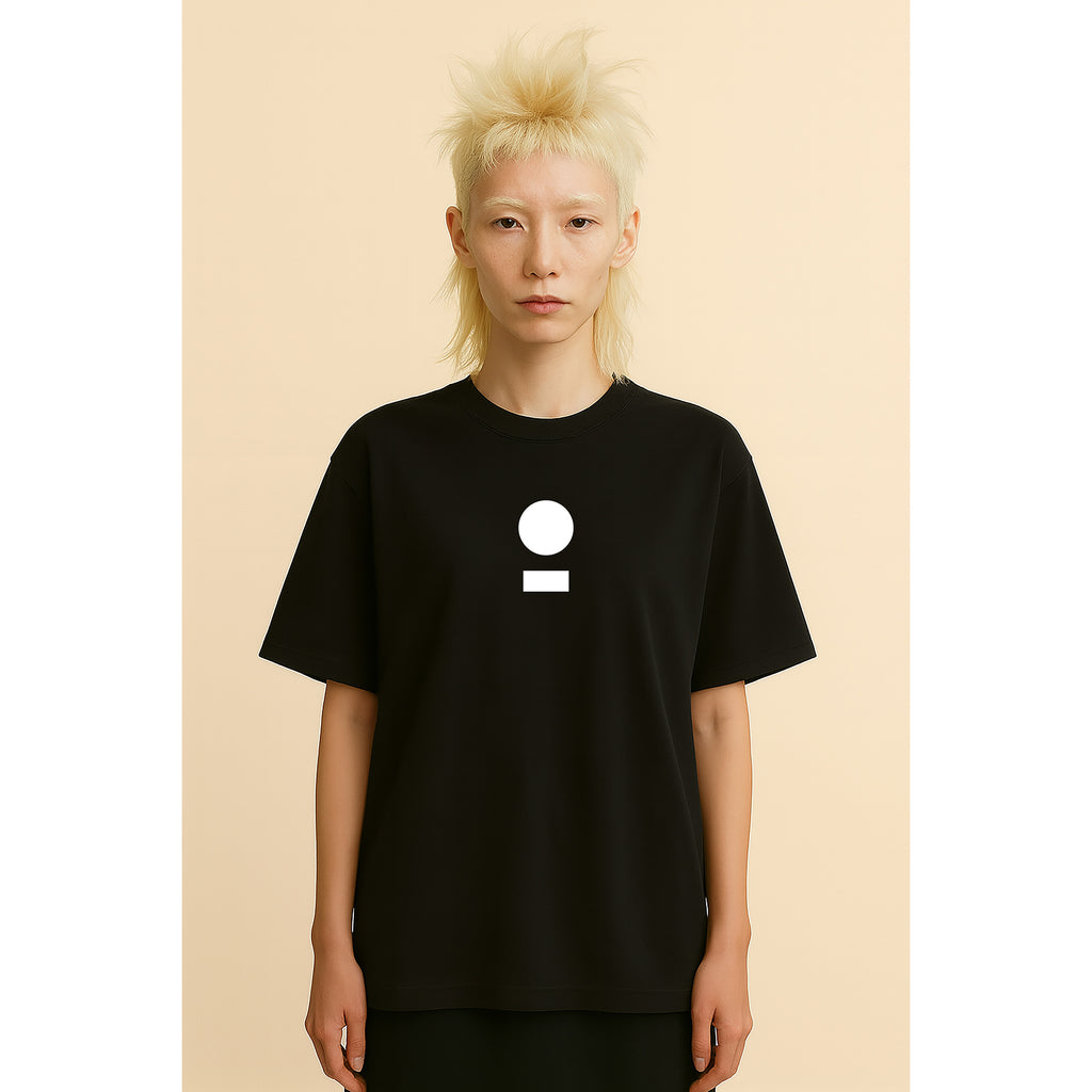 Model wears nomad_07 Logo Heavyweight Tee in Onyx with centered core logo, oversized unisex fit.