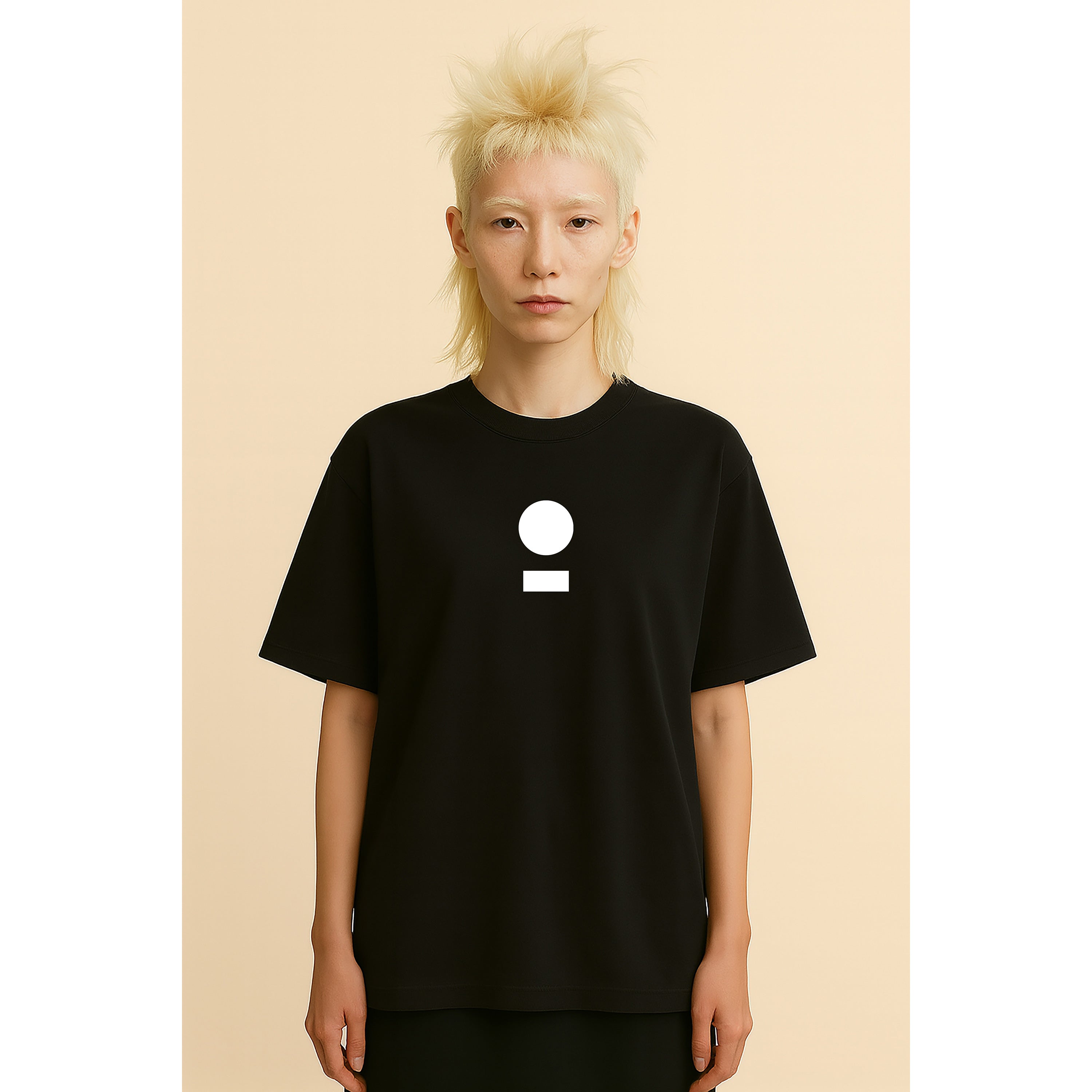 Model wears nomad_07 Logo Heavyweight Tee in Onyx with centered core logo, oversized unisex fit.