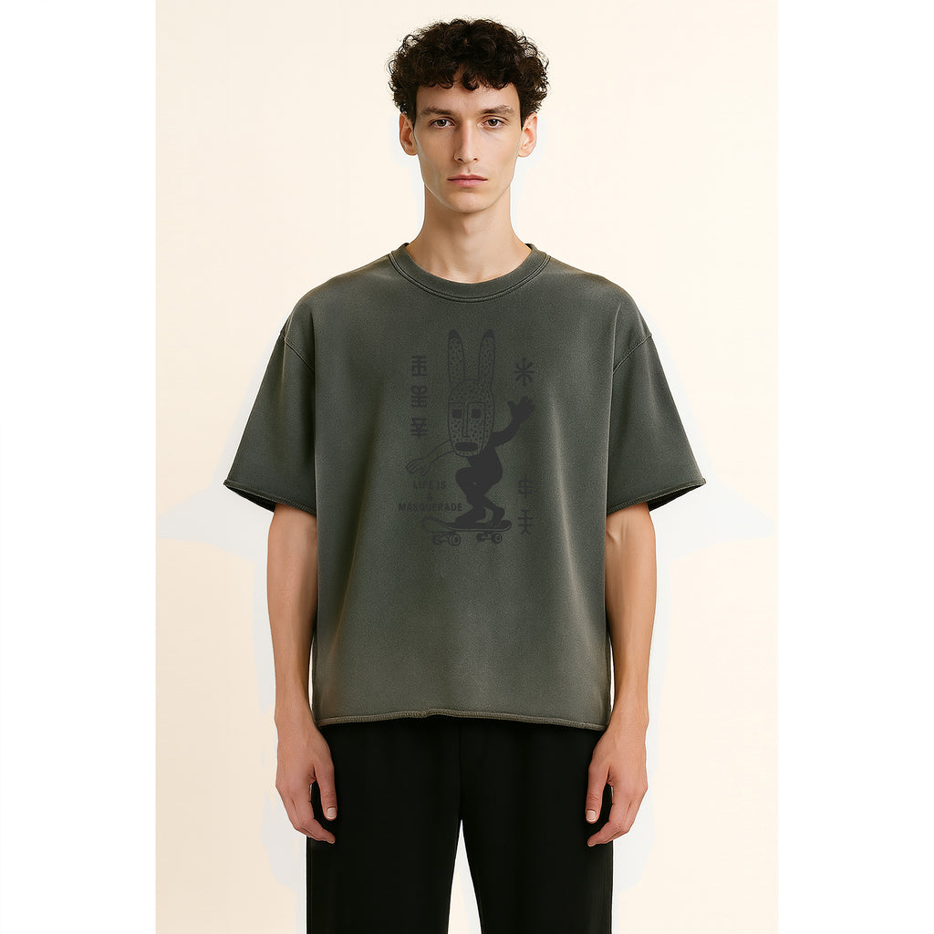 A model wears nomad07 sunfade washed t shirt with dogon skate graphic in dark grey