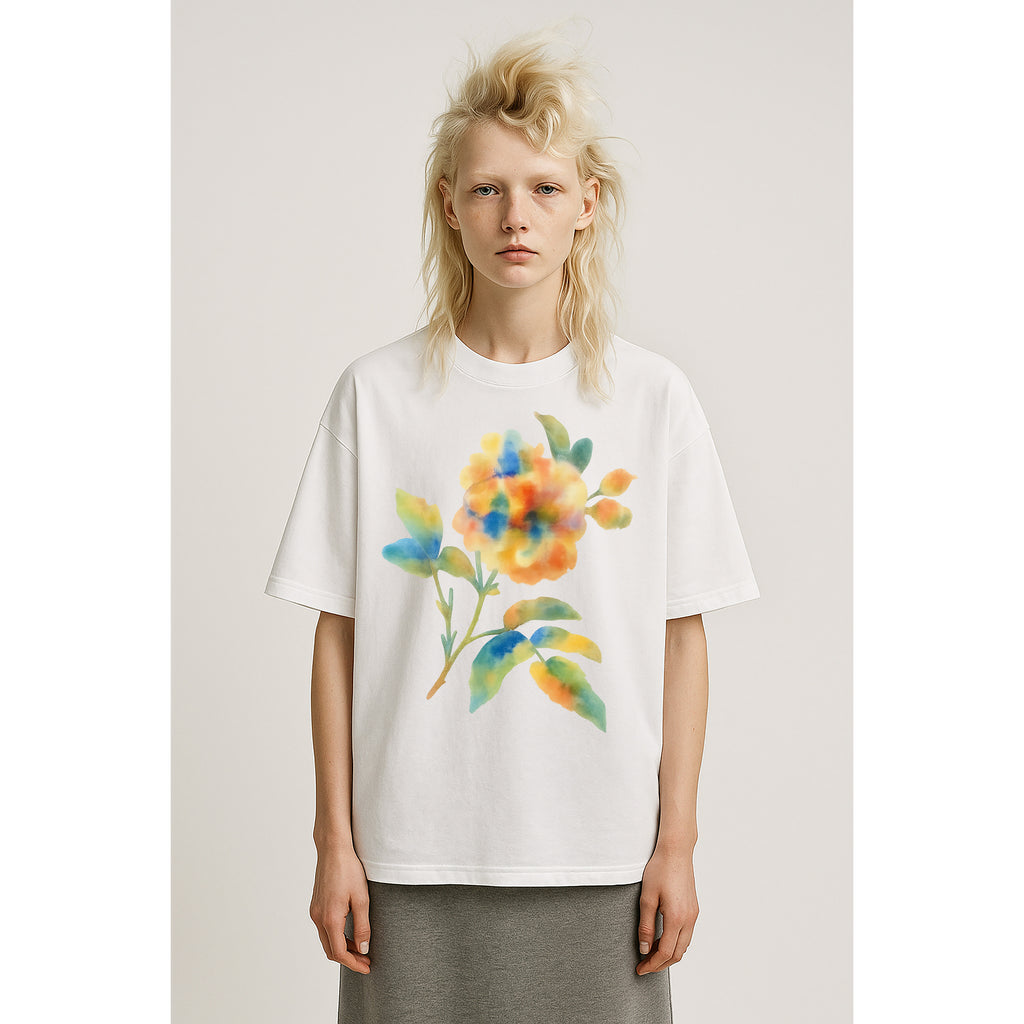 Model wears oversized heavyweight white tee shirt with large watercolor floral multicolor print on solid background