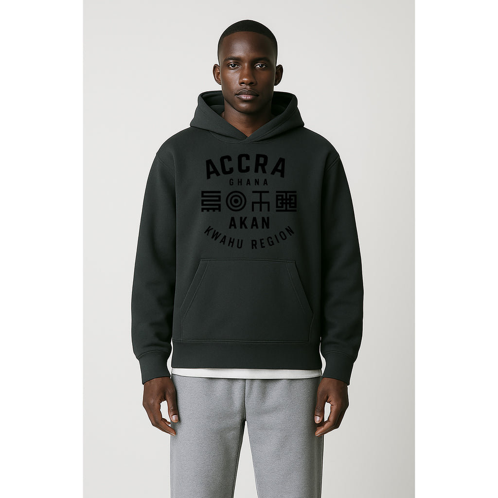 Model wears the Akan Script Heavyweight Hoodie in Dark Ash with tonal Adinkra-inspired graphic celebrating Accra and Akan cultural symbolism